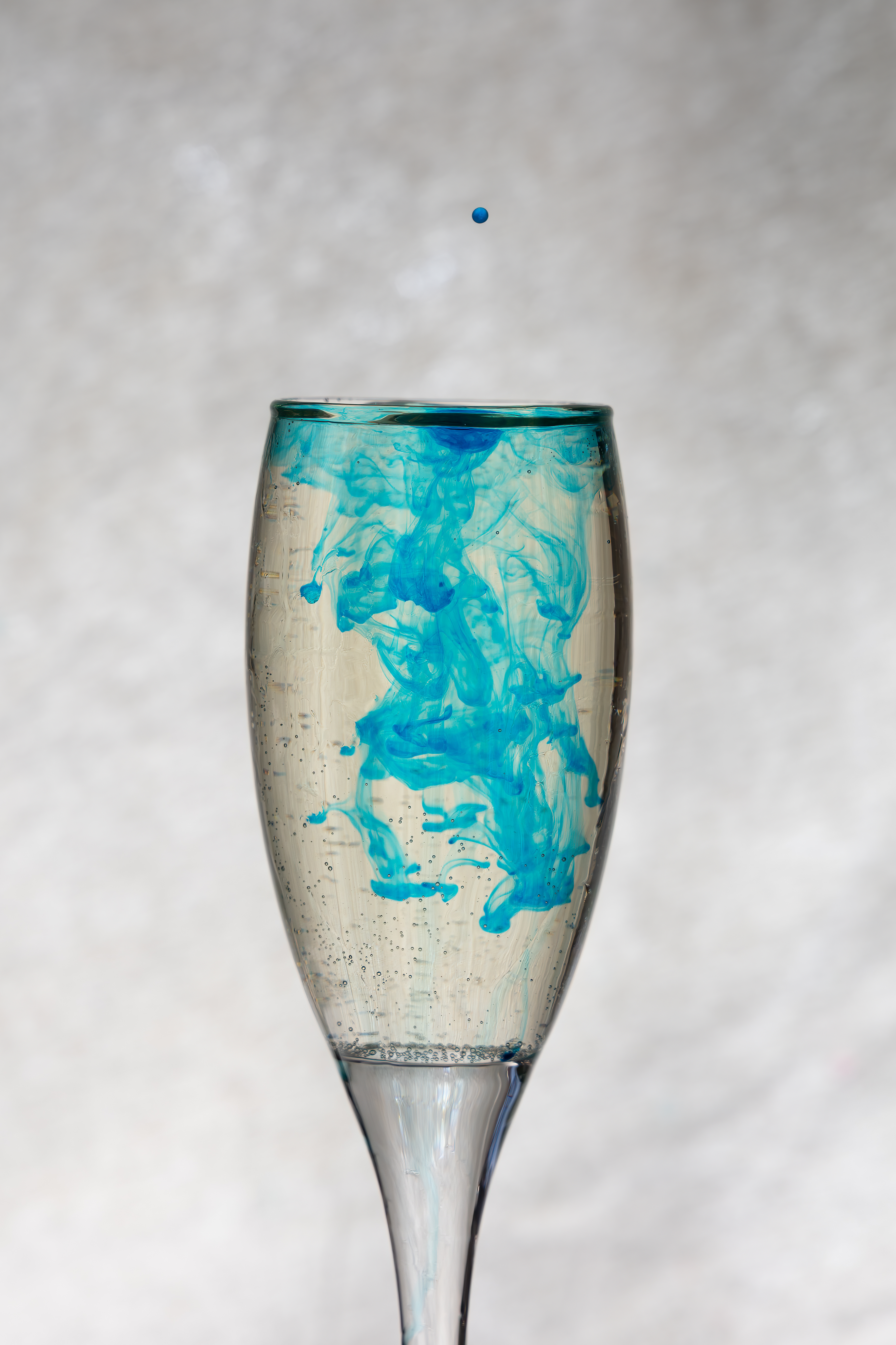 Inception — single ink drop falling into a glass